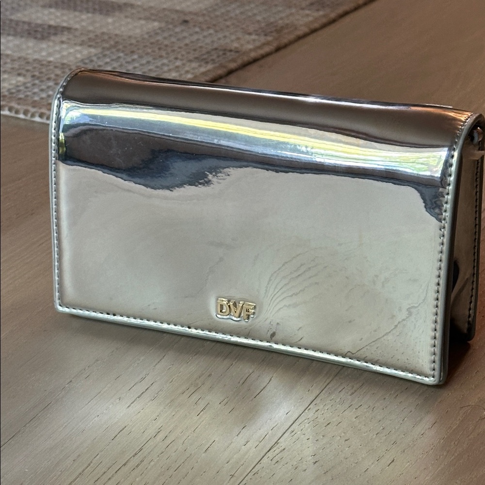 Diane Von Furstenberg Metallic Silver sleek crossbody bag w/ gold colored chain